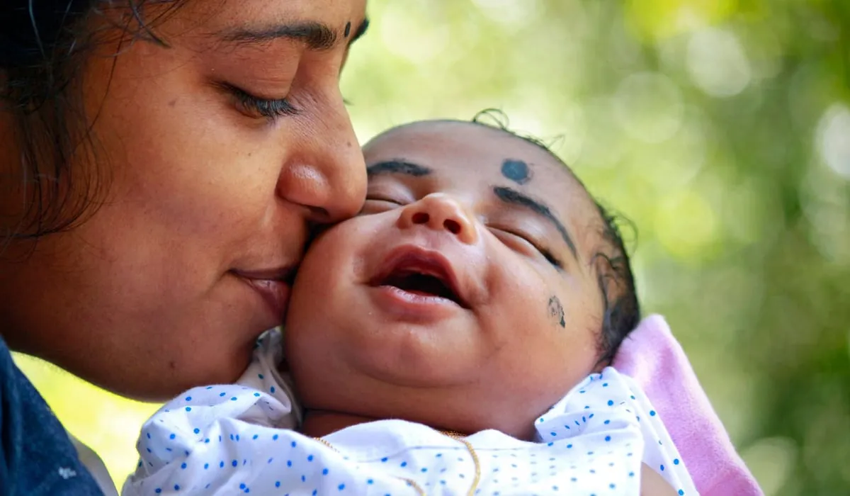 A mother holding her baby close