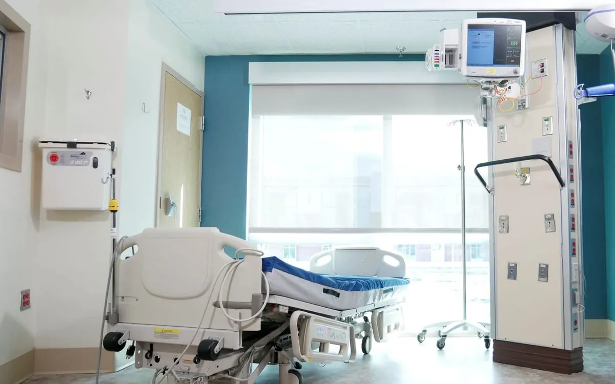 A modern hospital room with a bed and monitors