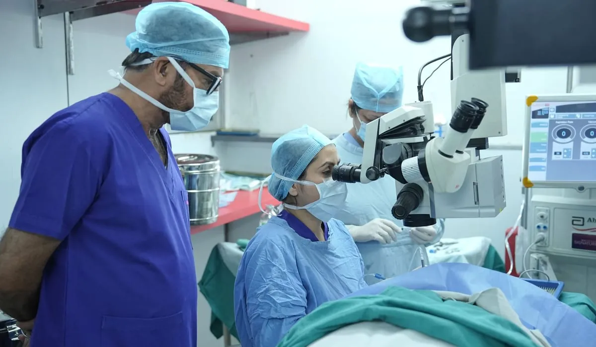 Surgeons in caps and masks at work in an operating theatre
